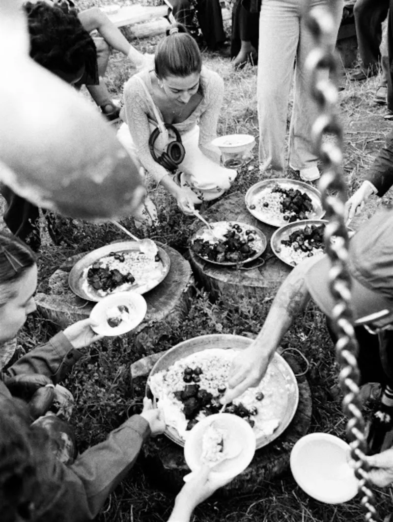 People sharing a meal on the grass.