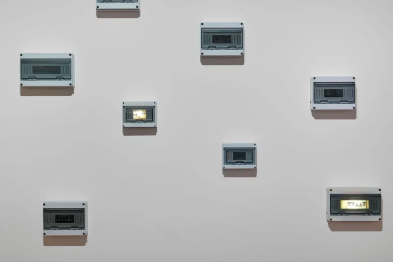 Joyce Joumaa, Periodic Sights (2025), time-based installation, inkjet prints on vellum paper, electrical enclosures, electronic timers and LED lights, dimensions variable. On view in Video Killed the Radio Star: The 1980s and their Cultural Echoes at Mudam Luxembourg (12 June – 11 October 2026). Mudam Luxembourg Collection. Donation 2025 – Baloise.