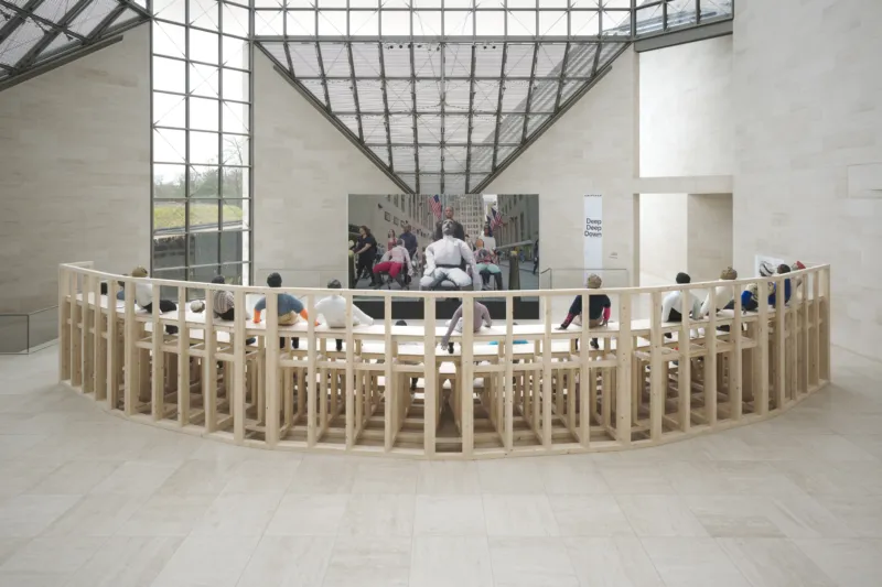 Oscar Murillo, ‘collective conscience’, 2015-ongoing. 30 papier mache and fabric effigies, wooden bleachers. Courtesy of the artist. View of the exhibition ‘A Model’, Mudam Luxembourg. Photo: Tim Bowditch © Mudam Luxembourg