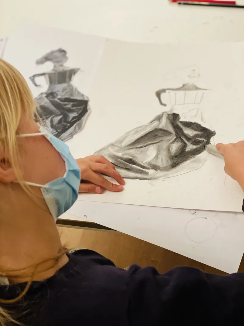 A child making a pencil drawing.