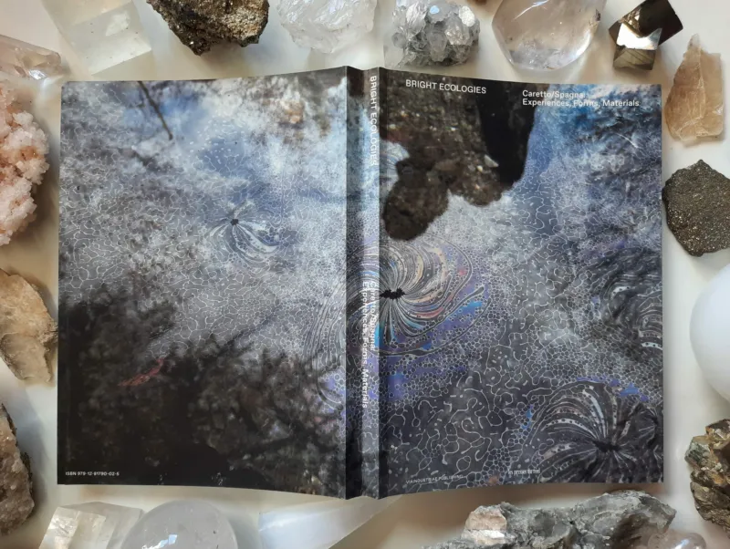 A beautifully decorated book cover with diverse stones laid on its sides.