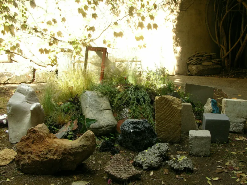 Diverse stones gathered ion a garden.