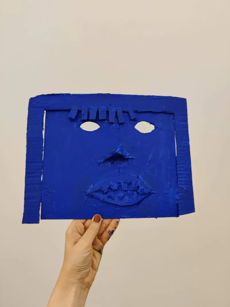 An orange mask made in a children's workshop at Mudam.