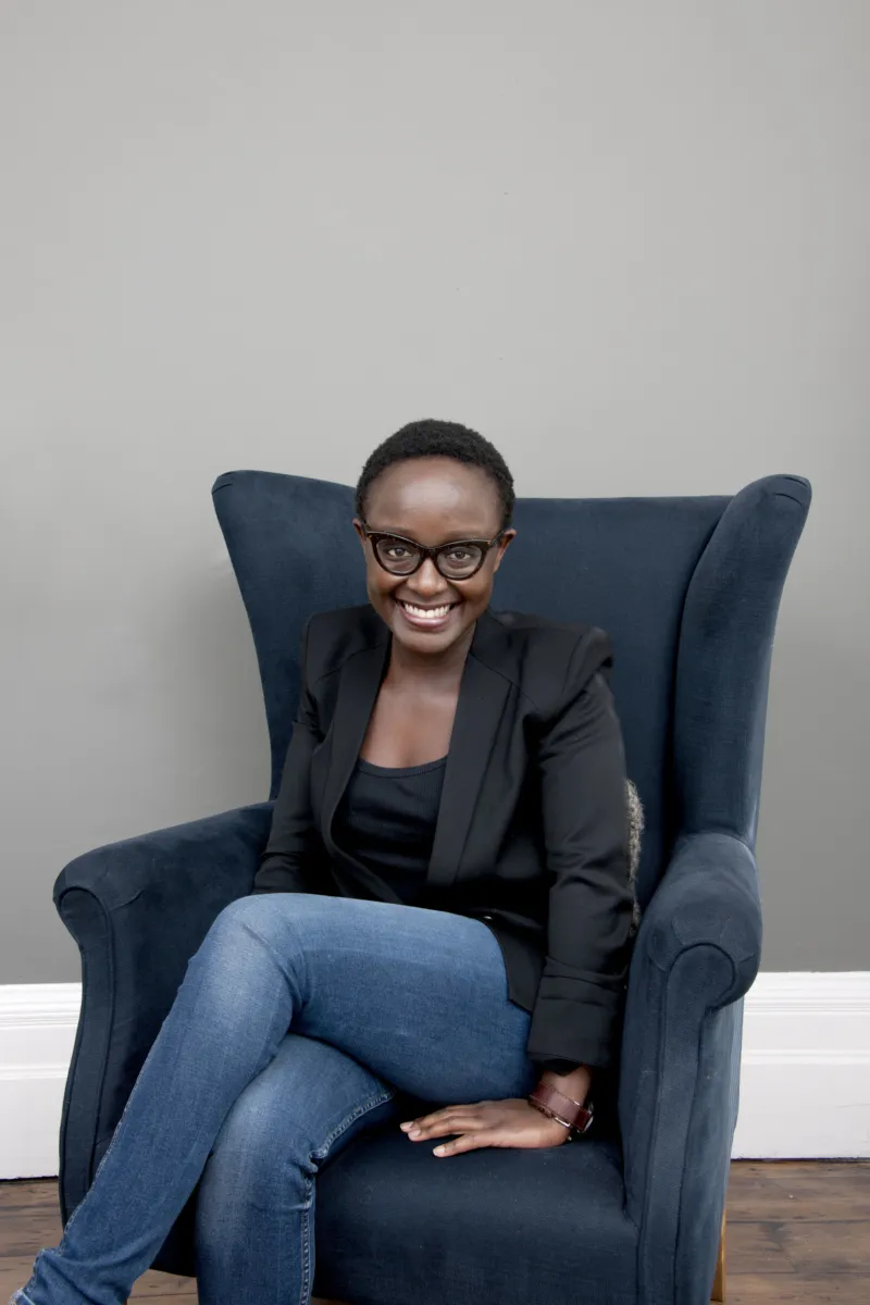 Portait of Lynette Yiadom Boakye sitting in an armchair.