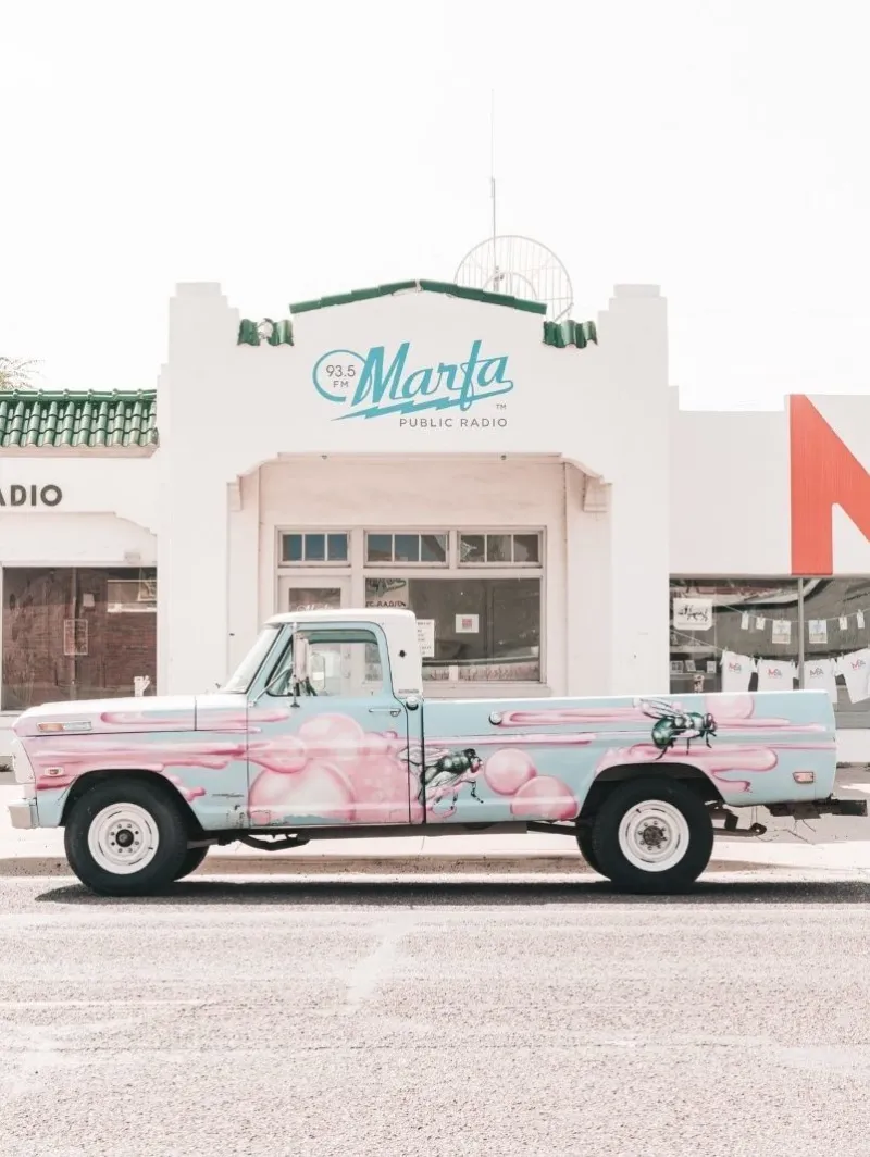 A colourful truck parked in front of the building of Marfa Public Radio in Texas.