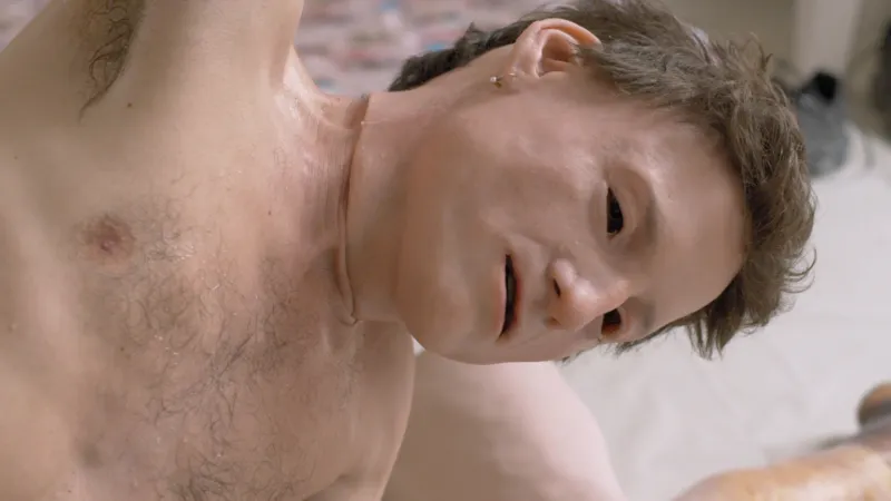A man wearing a flesh imitating mask.
