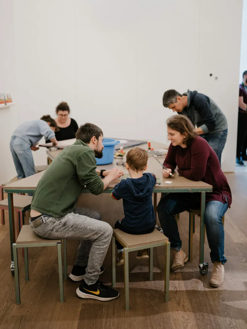 A family participating in a workshop at Mudam.