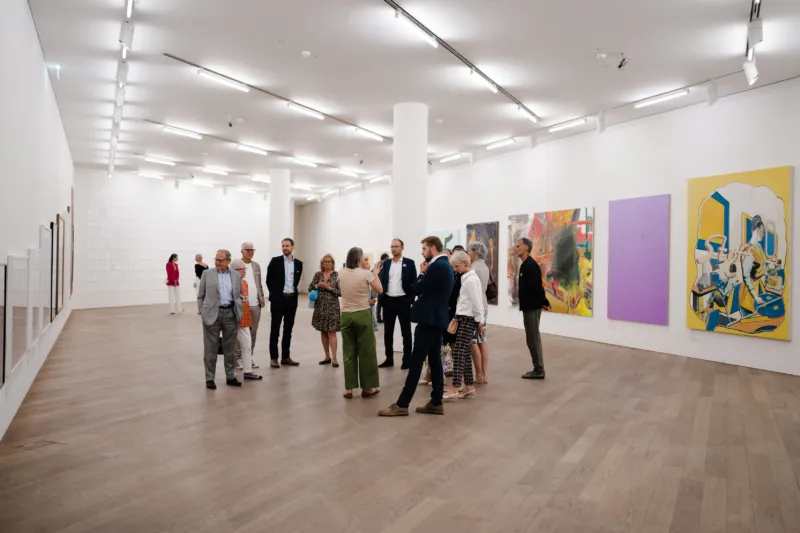 A group of people taking part in a guided tour of the Mudam Collection.