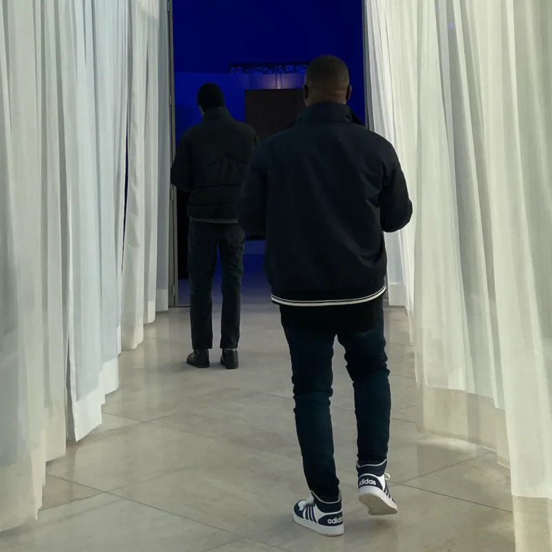 A group of people entering a blue coloured gallery at Mudam.