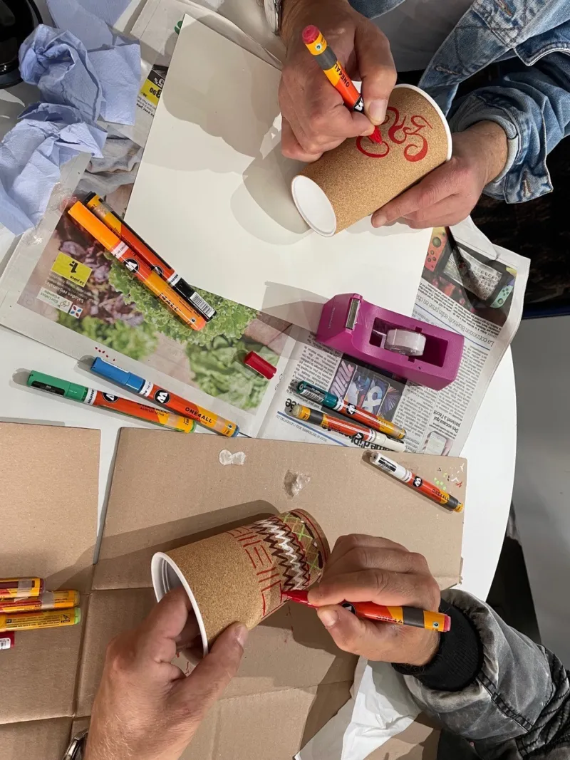 Close-up of people designing isothermal mugs.